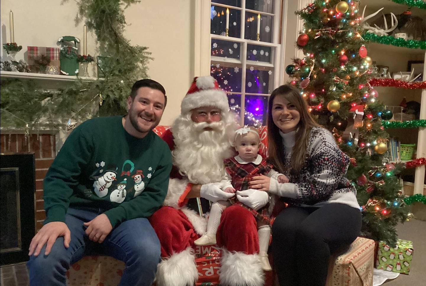 Family with Santa in front of fireplace
